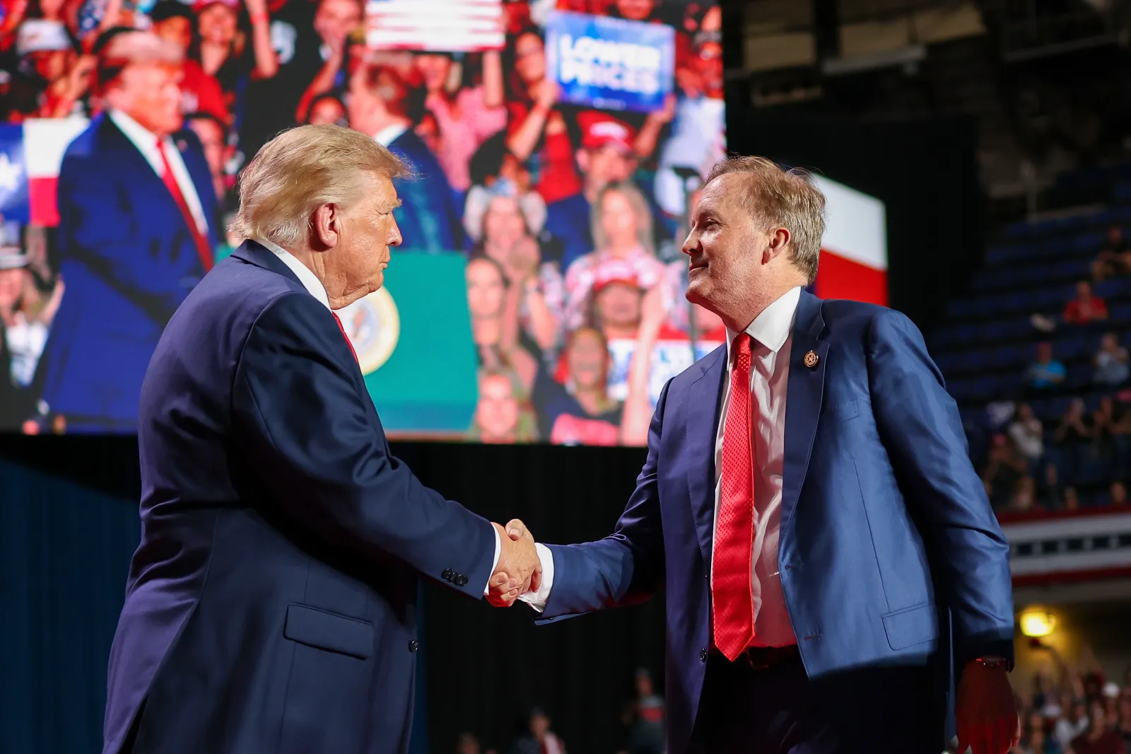 President Donald Trump (L) shakes hands with Republican Senate candidate Texas Attorney General Ken Paxton as he brings him on stage during a campaign rally at the Freeman Coliseum on October 7, 2026 in San Antonio, Texas.