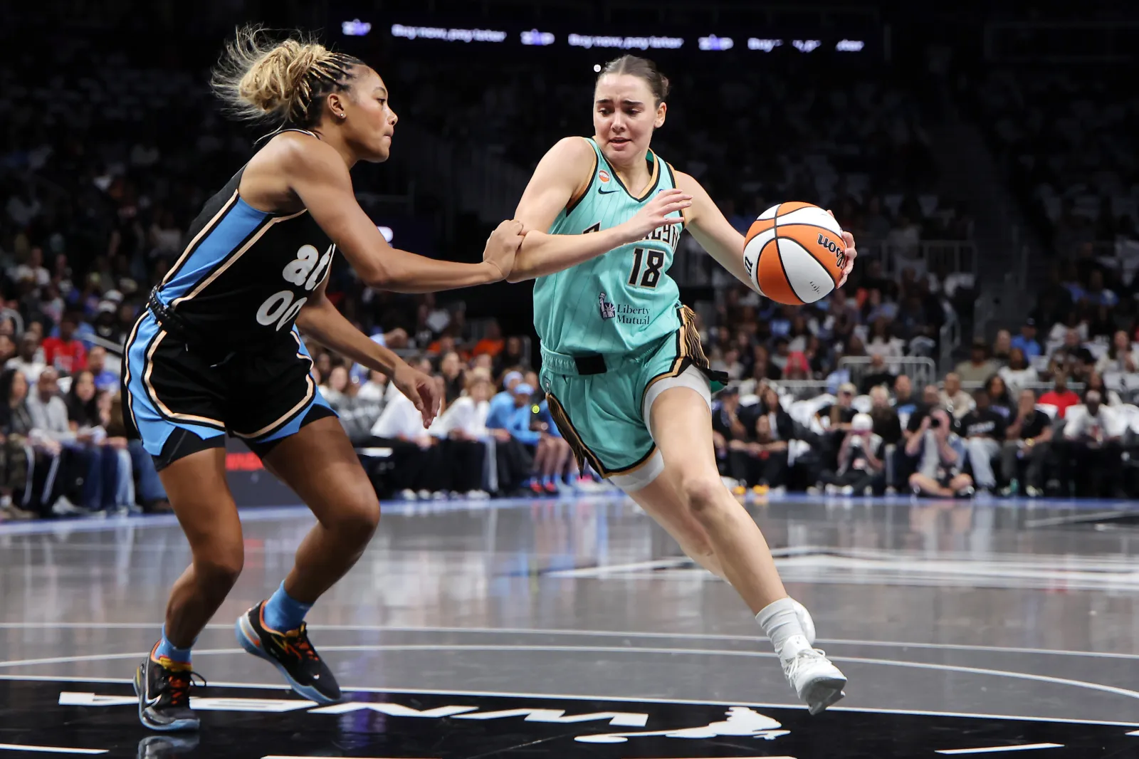 Pauline Astier #18 of the New York Liberty drives against Naz Hillmon #00 of the Atlanta Dream during the first half of game two of the semifinals of the WNBA playoffs at State Farm Arena on Oct. 07, 2026 in Atlanta, Georgia.
