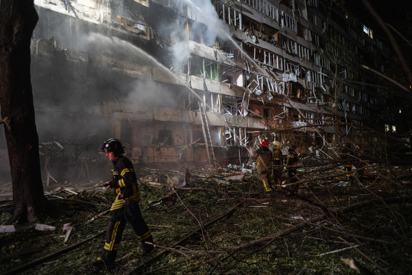 Ukrainian firefighters extinguish a blaze at the site of a Russian missile strike in Kyiv on October 14, 2026.