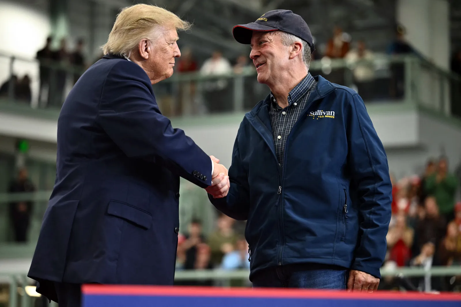 US President Donald Trump shakes hands with US Senator Dan Sullivan (R-AK) during a campaign rally at Curtis D. Menard Memorial Sports Center in Wasilla, Alaska, on October 13, 2026.