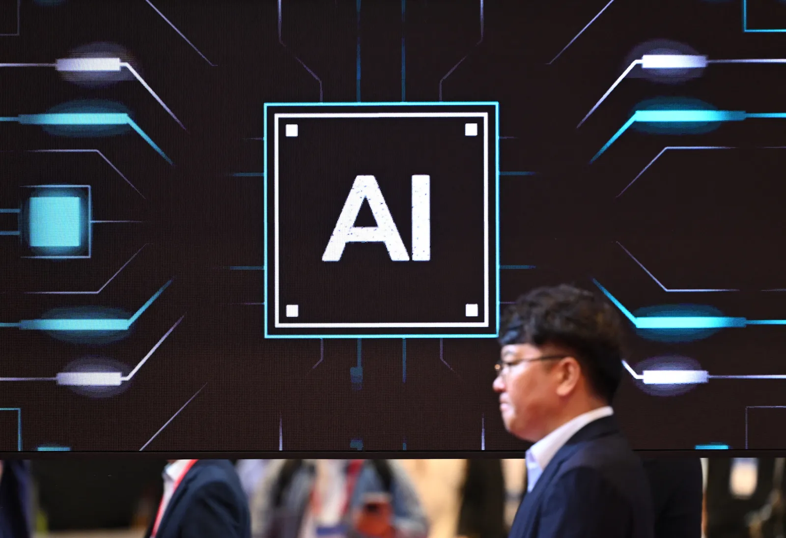 A man walks past a screen showing an image for artificial intelligence (AI) in Seoul on October 14, 2026.