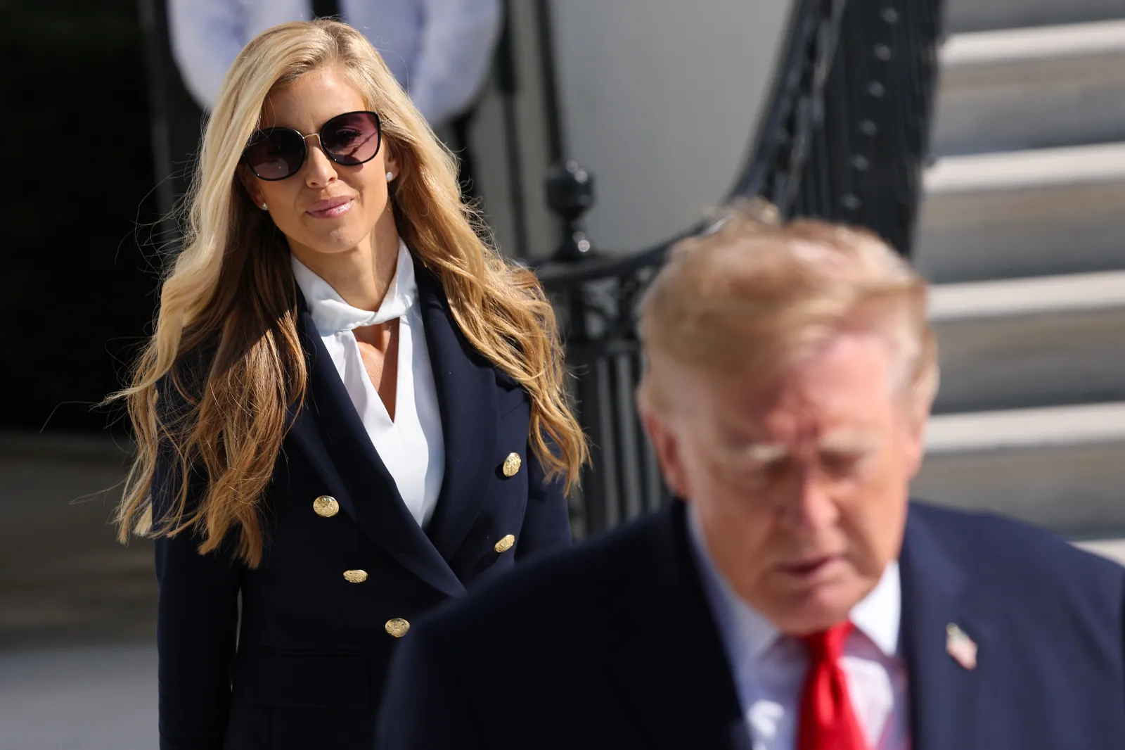 White House press secretary Katie Zacharia (L) joins U.S. President Donald Trump as he departs on the South Lawn of the White House on October 13, 2026 in Washington, DC.