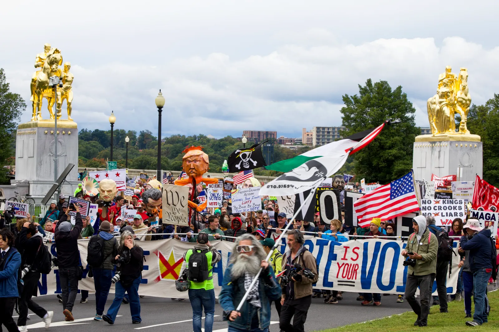 Demonstrators take part in a "No Kings: Vote Early" rally near Arlington Memorial Bridge in Arlington, Virginia, on October 17. (Photo by Amid FARAHI / AFP via Getty Images)