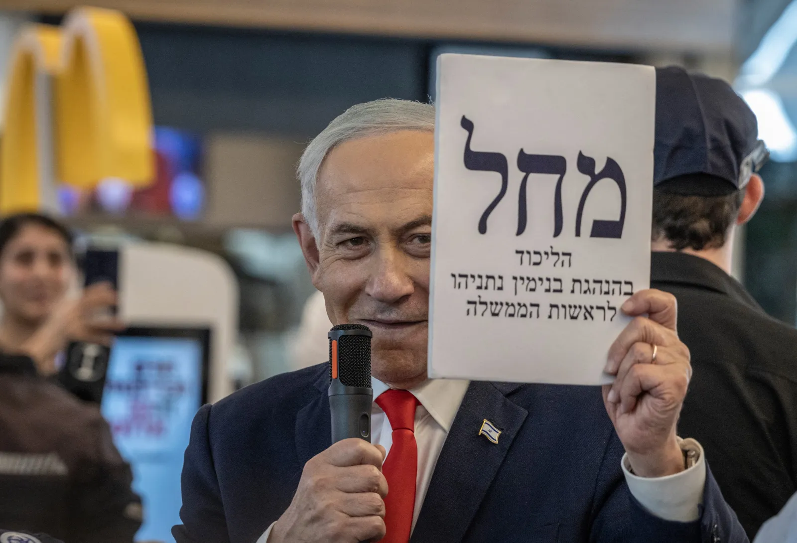 Israeli Prime Minister Benjamin Netanyahu holds up an enlarged copy of a Likud party ballot at a mall in Ramle on October 19, 2026.