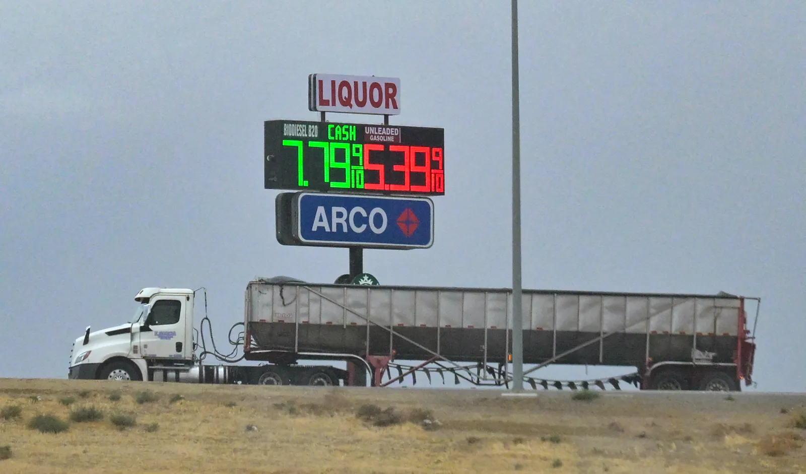 An 18-wheeler truck transporting agricultural products passes a gas station near Lost Hills in Kern County, California, on October 21, 2026.