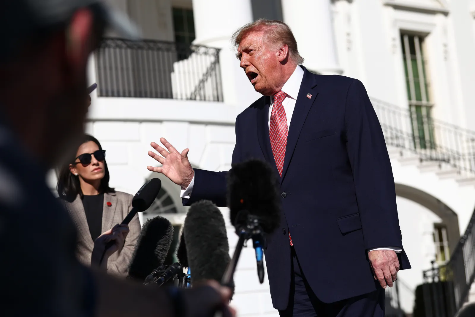 President Donald Trump defended his decision to waive new Russia sanctions while speaking to reporters as he departed the White House on Monday.