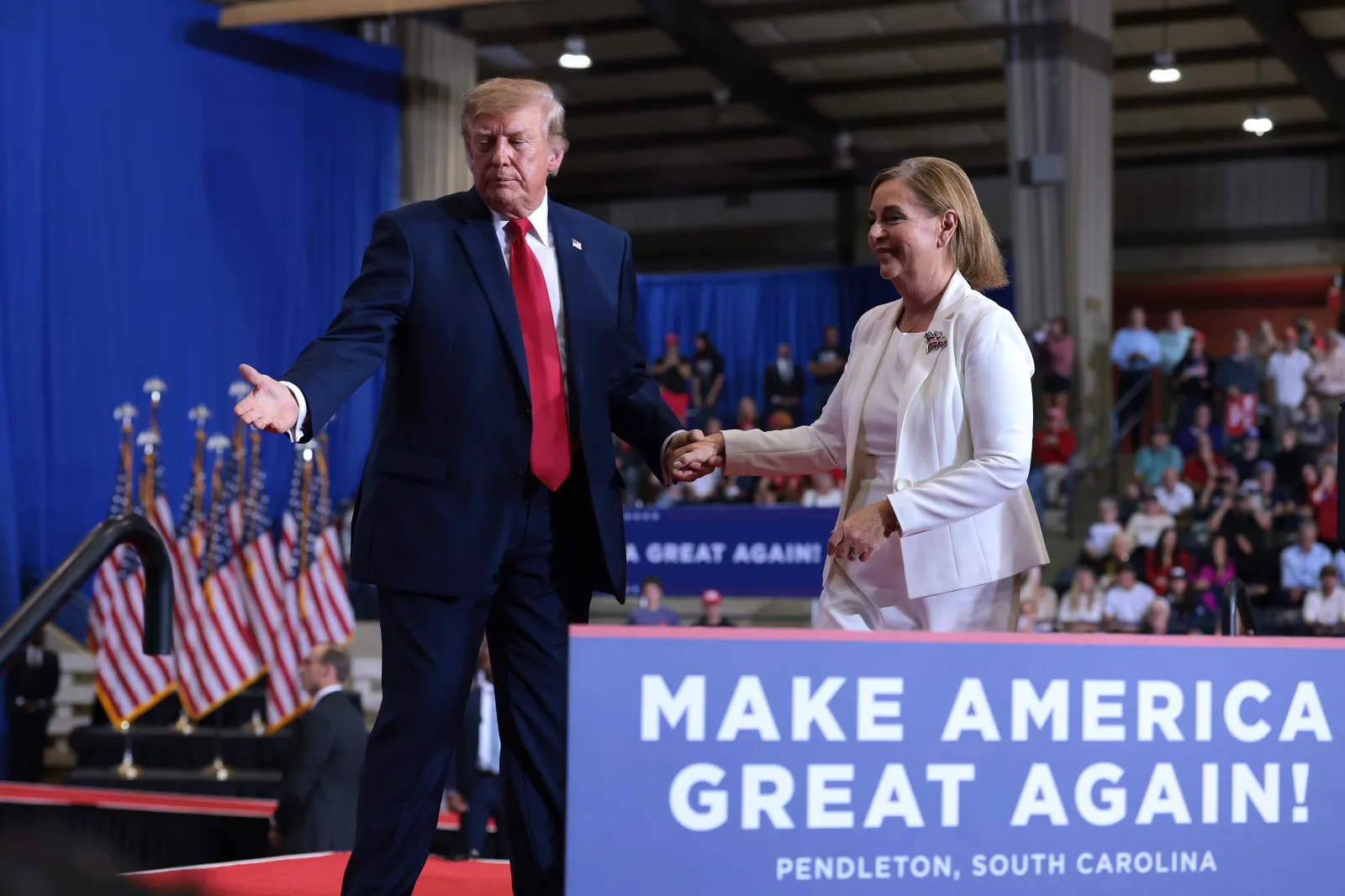 President Donald Trump escorts Republican Senate nominee Senator Darline Graham off the stage during a campaign rally at T. Ed Garrison Arena at Clemson University on October 21, 2026, in Pendleton, South Carolina.