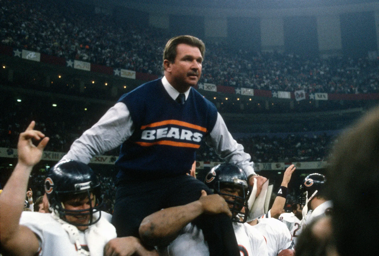 Head Coach Mike Ditka of the Chicago Bears gets carried off the field after they defeated the New England Patriots