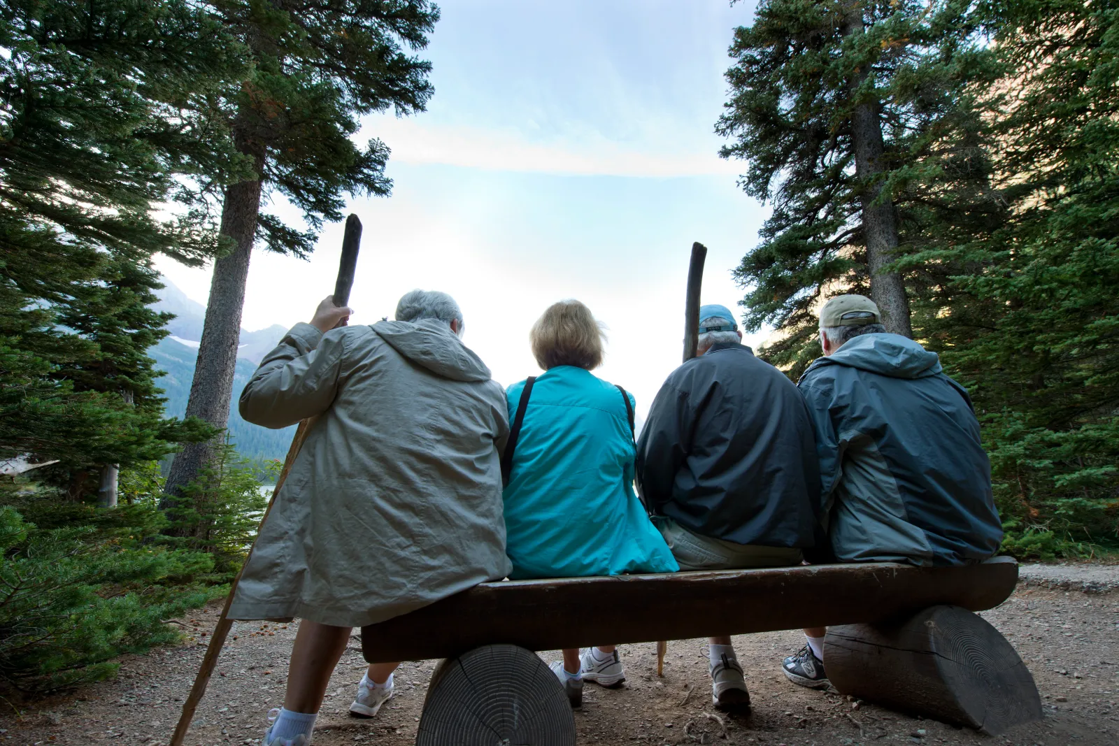 Undated stock image of older hikers taking a break on a trail.