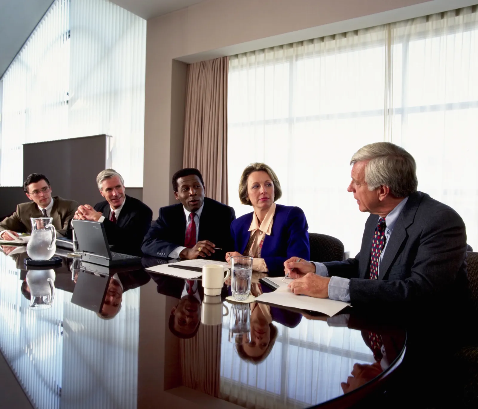Stock image: Executives meeting in a conference room.