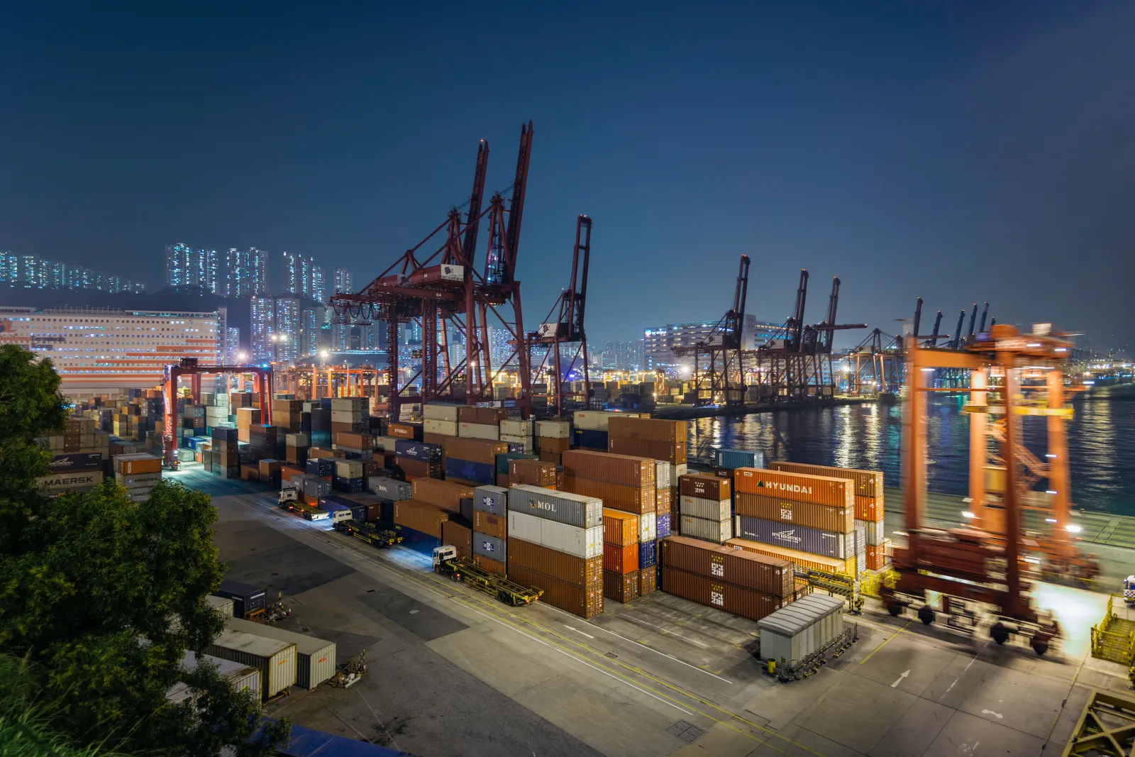 Undated file image shows cranes and containers at a Hong Kong container port, at dusk.