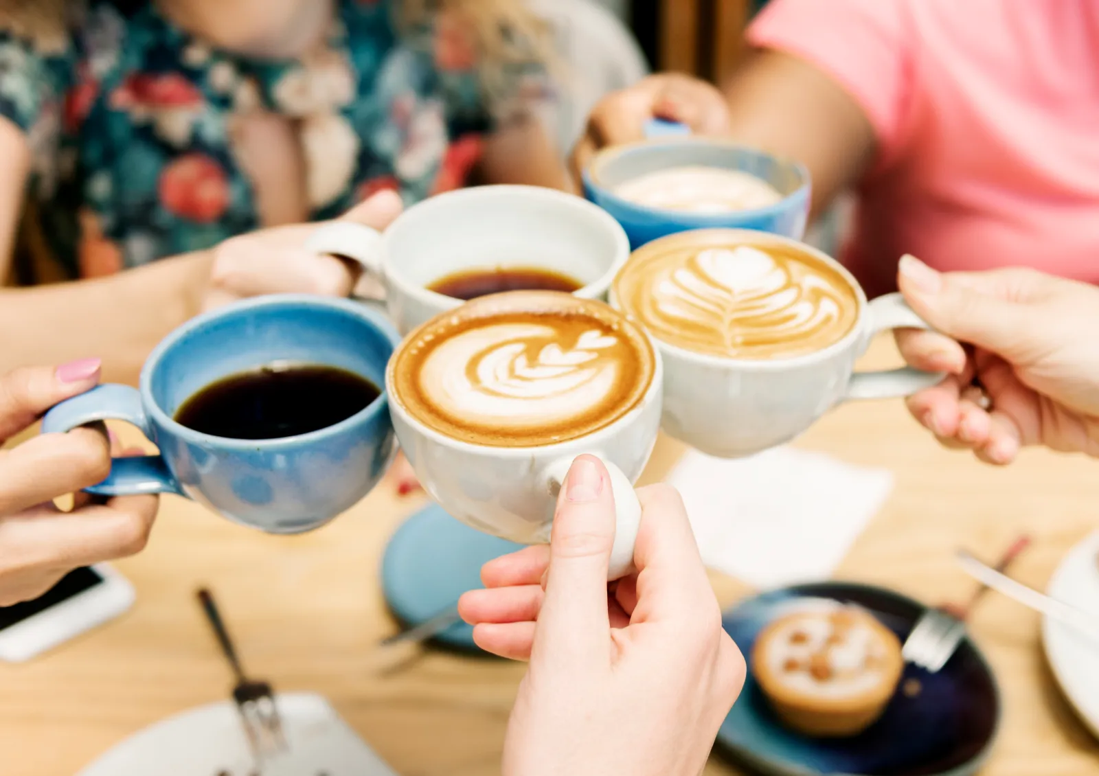 A stock image shows a group of people having coffee.