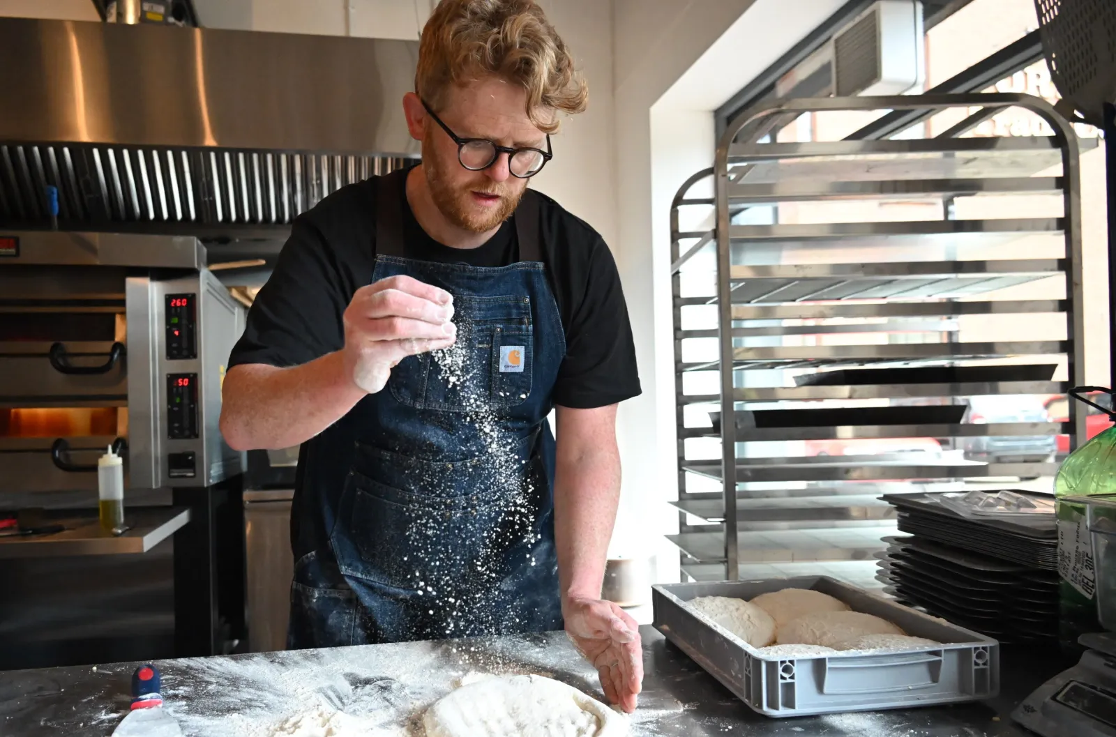Peter Thompson, owner of Flout!, makes pizza dough in his first retail outlet in Portview Trade Centre in Belfast, Northern Ireland, in 2022. | Flout!