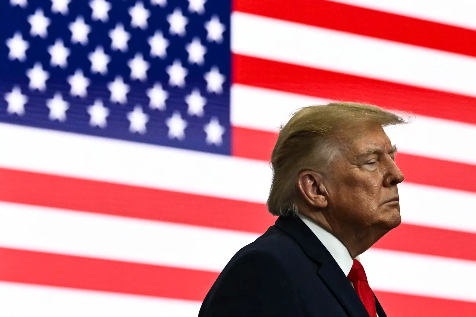 President Donald Trump backed by an American flag at a rally in Wasilla, Alaska, on October 13, 2026.