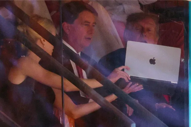 Natalie Harp shows President Donald Trump a laptop screen during the Texas-Tennessee football game at Neyland Stadium on September 26, 2026.