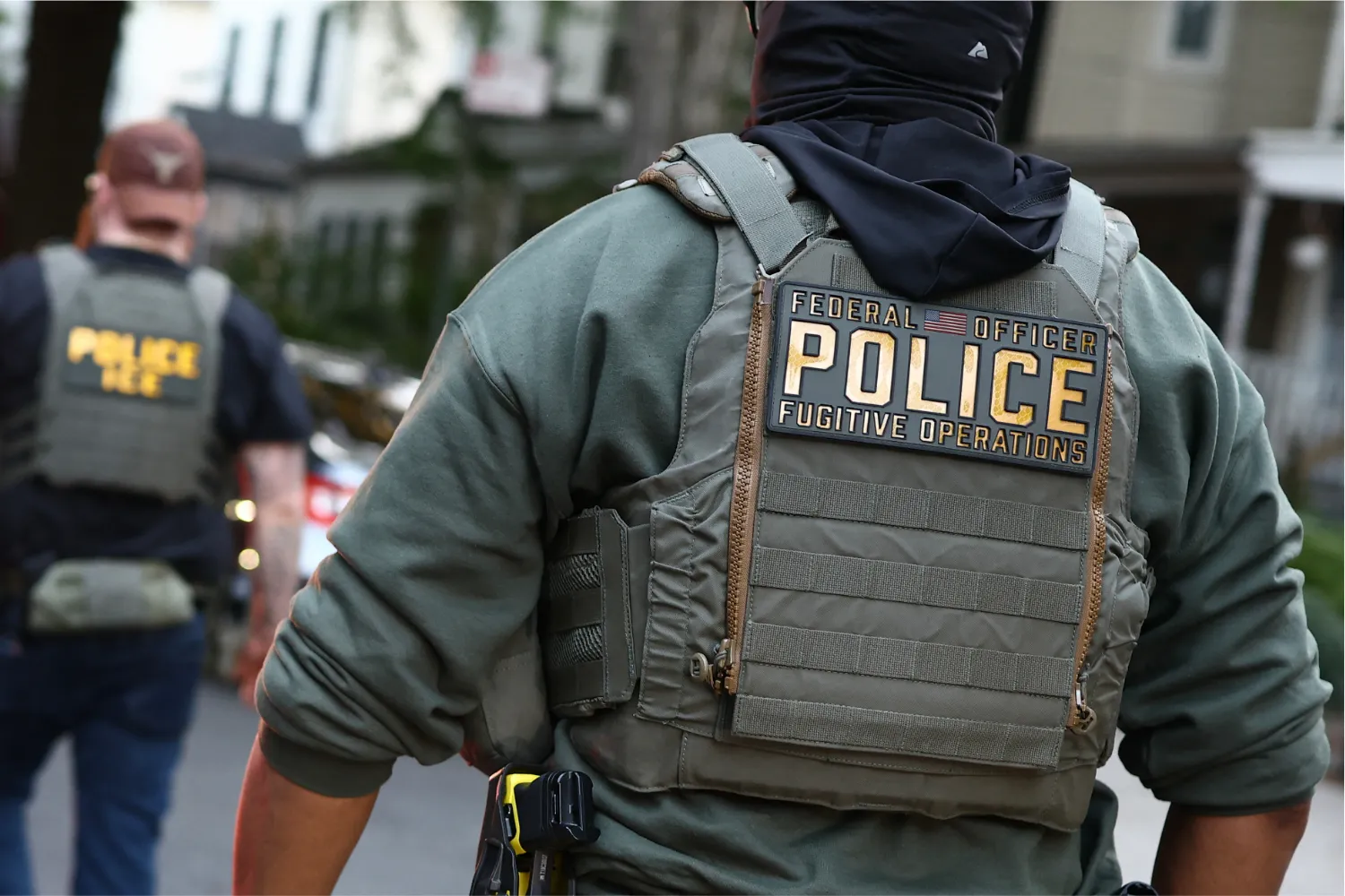 Federal agents walk near the scene where a man was shot by a U.S. Immigration and Customs Enforcement officer during an operation in the Bronx borough of New York City on October 8.