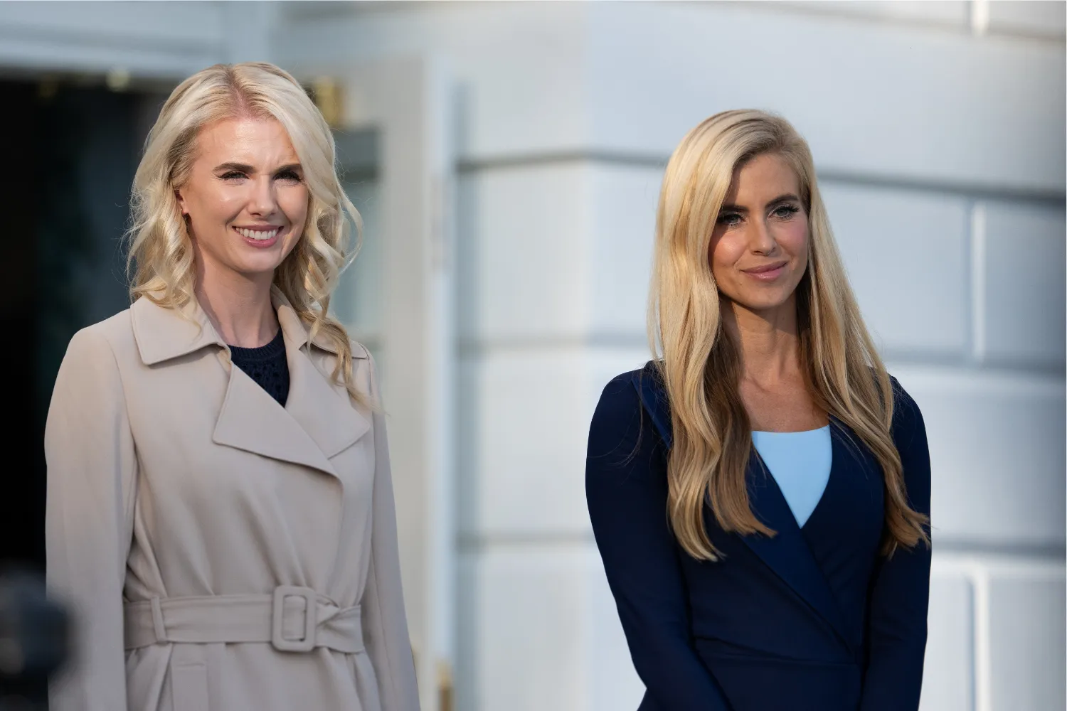 Executive Assistant to the President Natalie Harp, left, stands with White House Press Secretary Katie Zacharia on the South Lawn as they depart the White House in Washington, D.C., on October 12, 2026.