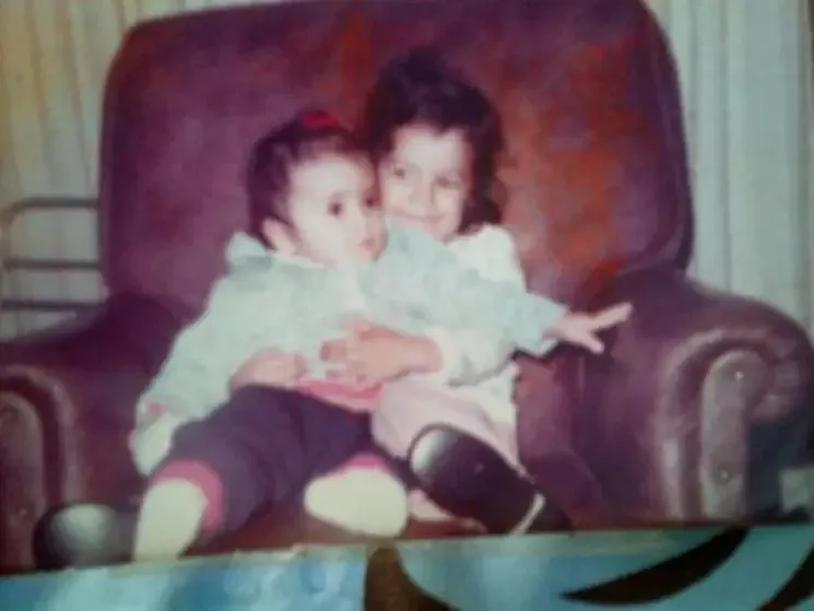 Leslie Vooris holding her little sister.